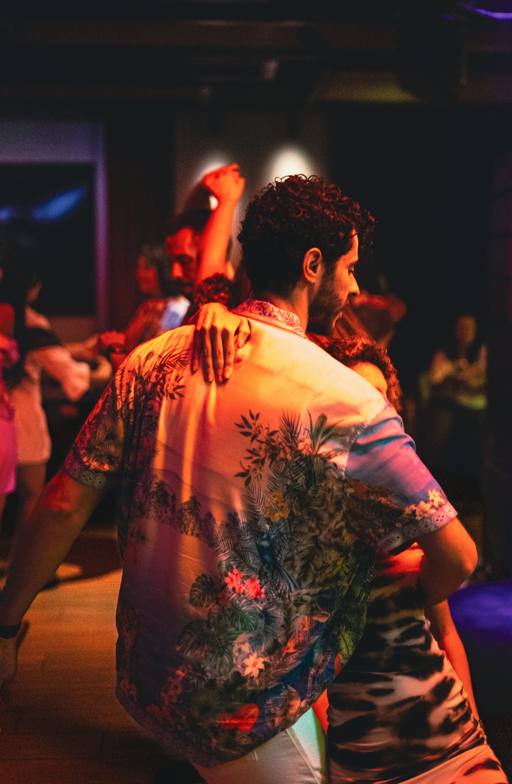 Kırmızı ışıklar altında yakın dans eden çift